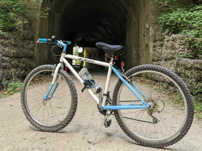 image showing a vintage bicycle against a tunnel on a trail